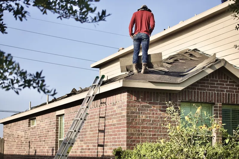 Professional roofer working on a residential roof in Fishers Hill
